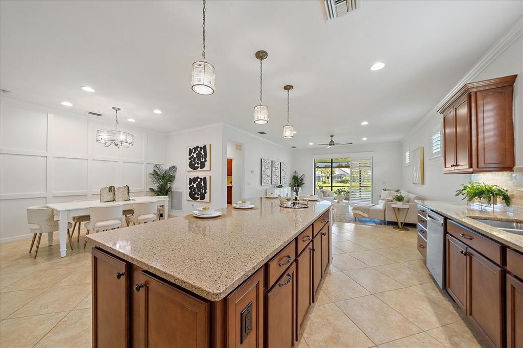 6713 Chester Trail Lakewood Ranch, FL 34202 - Photo 11 of 45 a kitchen with stainless steel appliances granite countertop a sink a stove and a refrigerator
