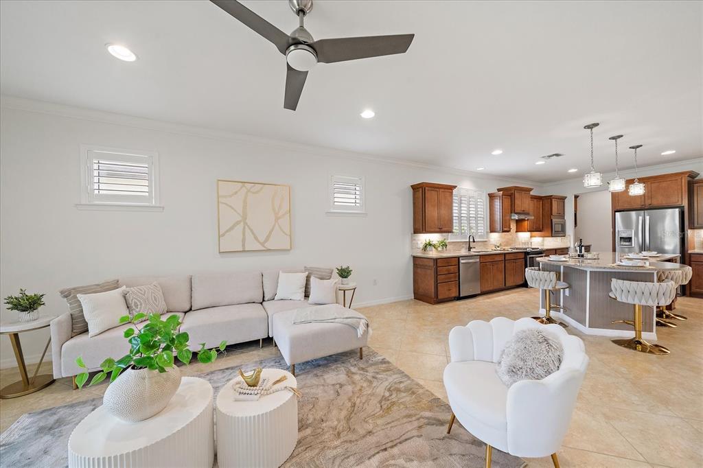 6713 Chester Trail Lakewood Ranch, FL 34202 - Photo 17 of 45 a living room with furniture kitchen view and a potted plant