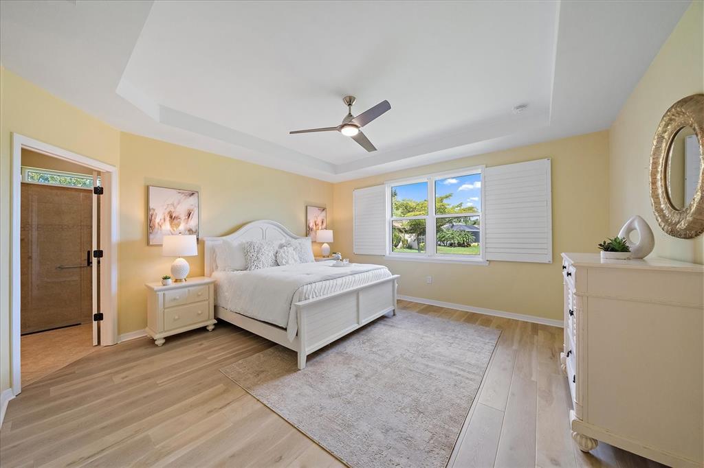 6713 Chester Trail Lakewood Ranch, FL 34202 - Photo 18 of 45 a spacious bedroom with a bed and a window