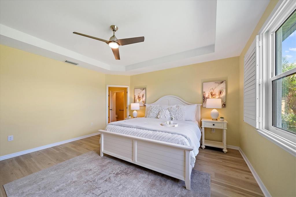 6713 Chester Trail Lakewood Ranch, FL 34202 - Photo 19 of 45 a bedroom with a bed and wooden floor