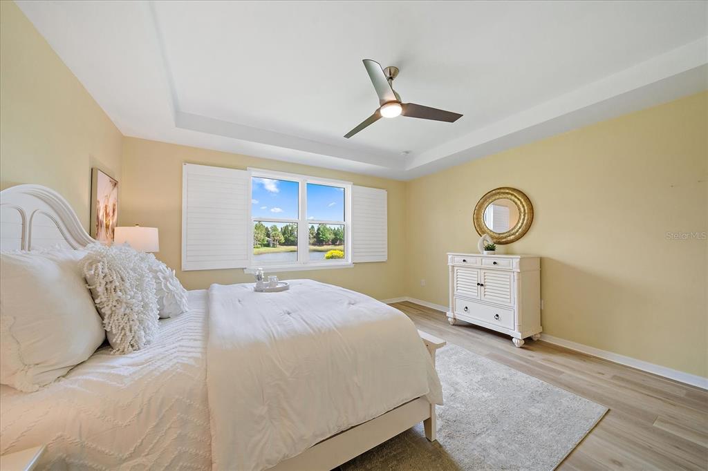6713 Chester Trail Lakewood Ranch, FL 34202 - Photo 20 of 45 a bedroom with a bed and a dresser