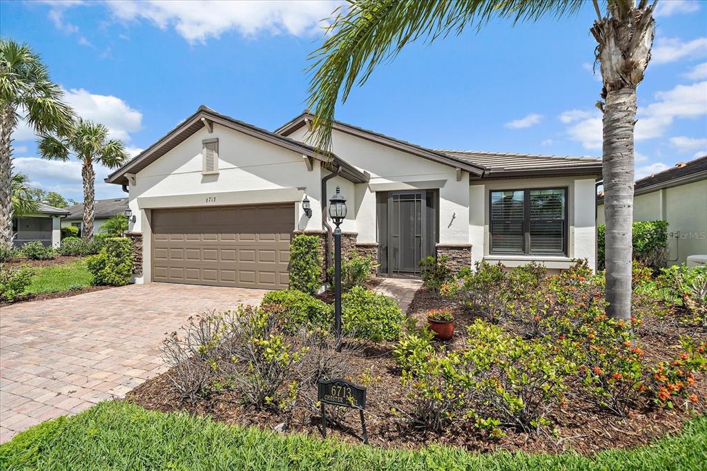 6713 Chester Trail Lakewood Ranch, FL 34202 - Photo 2 of 45 front view of a house with a yard