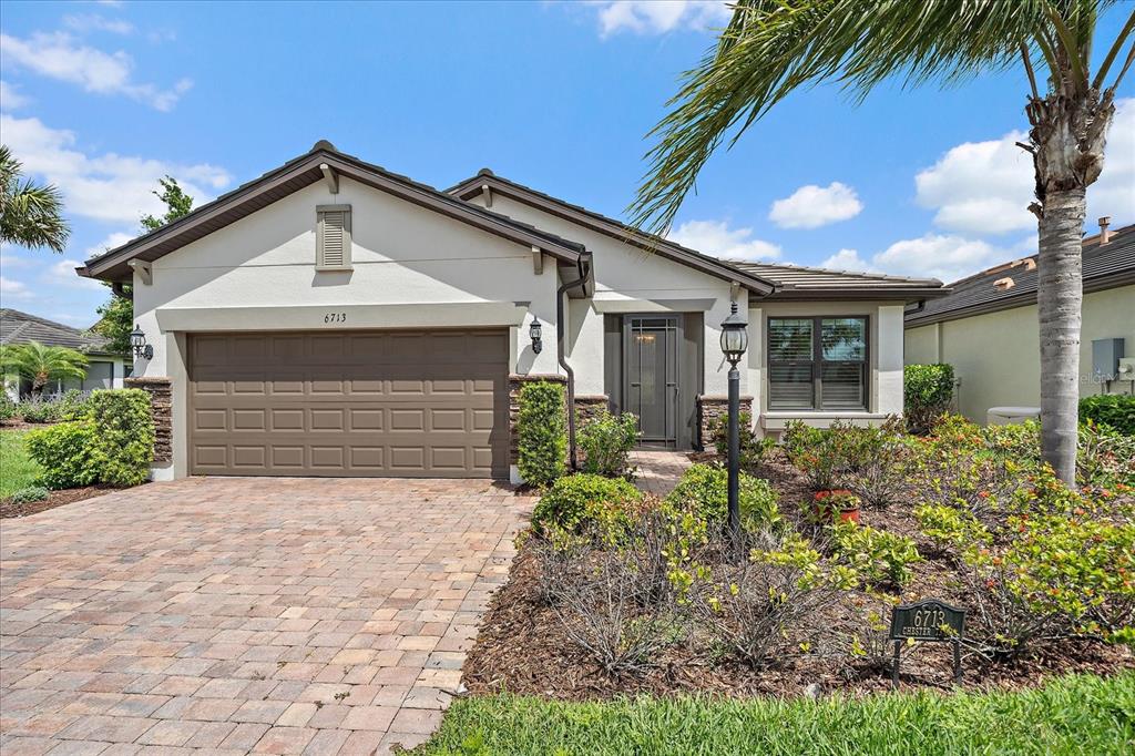 6713 Chester Trail Lakewood Ranch, FL 34202 - Photo 35 of 45 a front view of house with yard and green space
