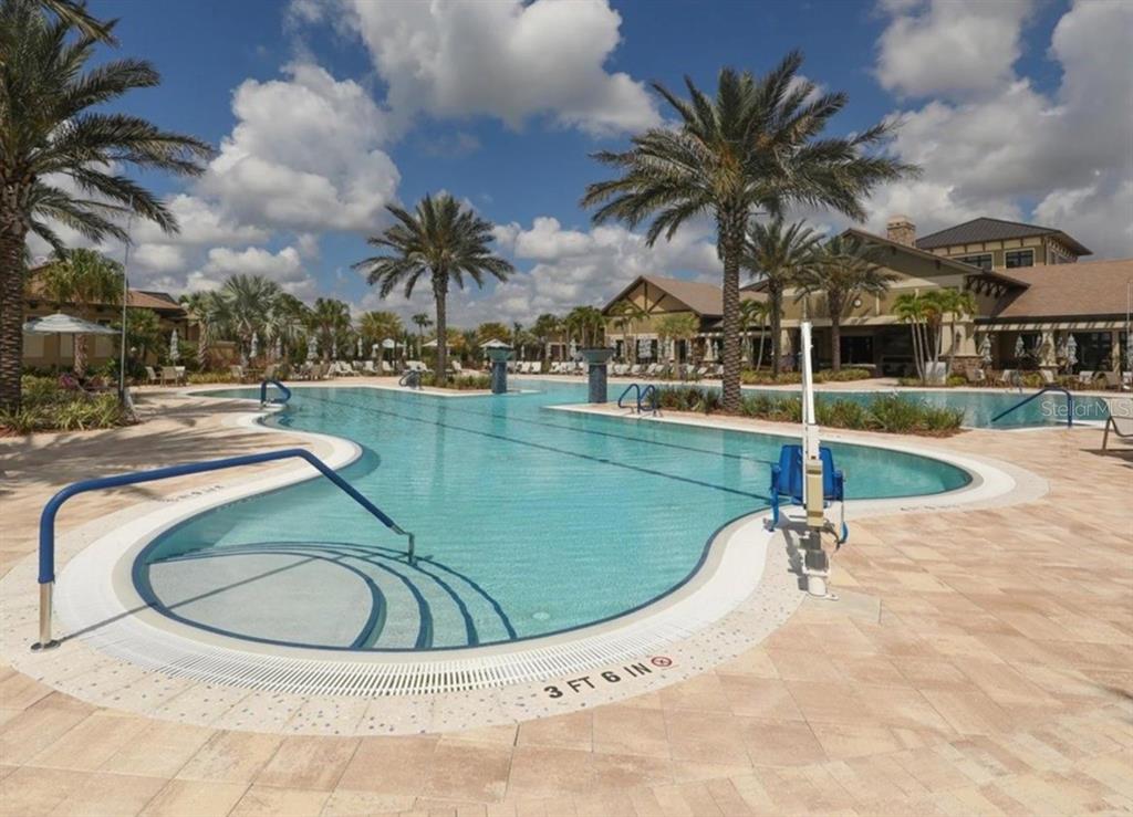 6713 Chester Trail Lakewood Ranch, FL 34202 - Photo 40 of 45 a view of a swimming pool with a table and chairs