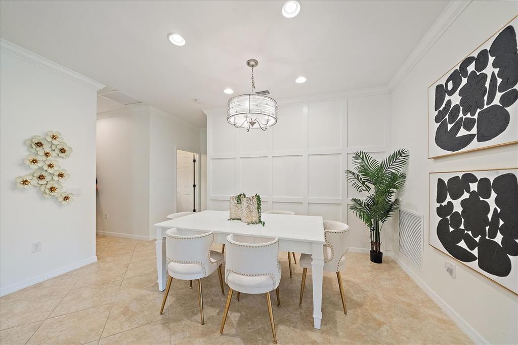 6713 Chester Trail Lakewood Ranch, FL 34202 - Photo 4 of 45 a dining room with furniture and chandelier