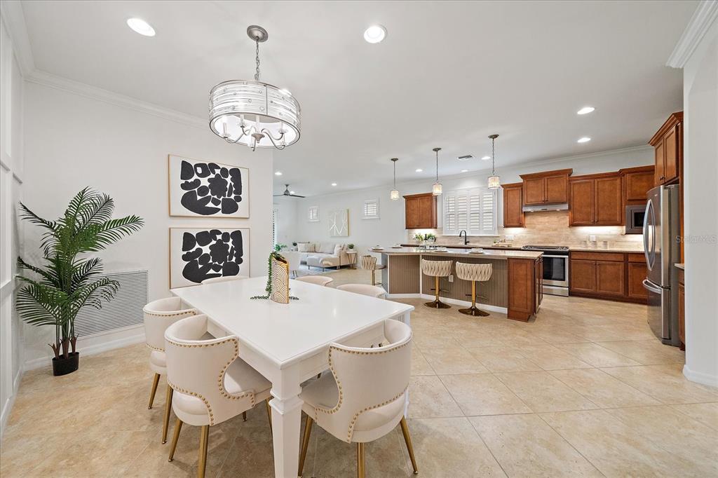6713 Chester Trail Lakewood Ranch, FL 34202 - Photo 5 of 45 a open dining room with stainless steel appliances kitchen island granite countertop furniture and a kitchen view