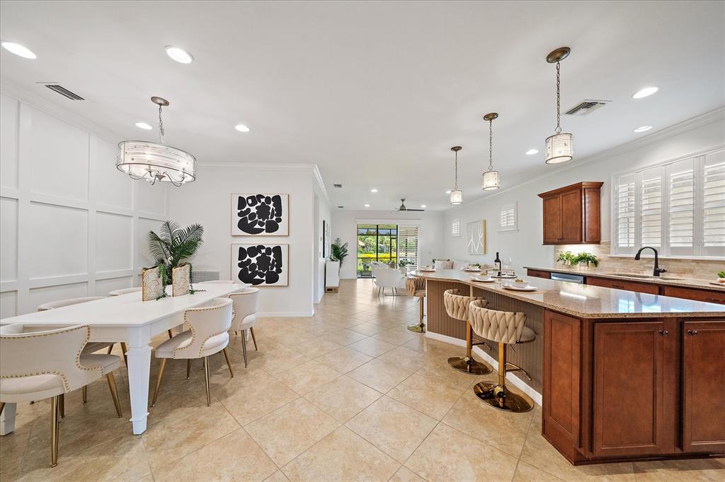 6713 Chester Trail Lakewood Ranch, FL 34202 - Photo 6 of 45 a kitchen with a table chairs and a view of living room