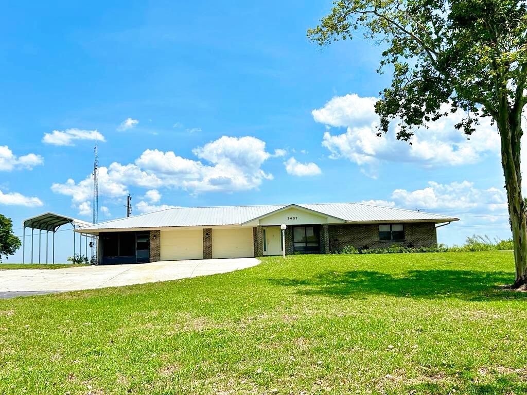 2657 River Road Moore Haven, FL 33471 - Photo 1 of 25 a backyard of a house with table and chairs