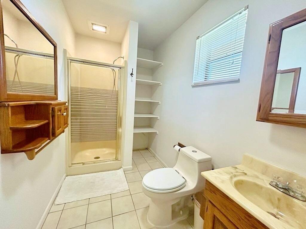 2657 River Road Moore Haven, FL 33471 - Photo 14 of 25 a bathroom with a sink a toilet and shower
