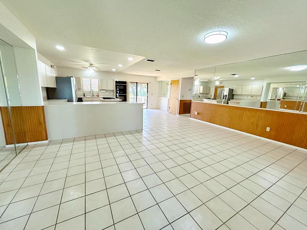 2657 River Road Moore Haven, FL 33471 - Photo 2 of 25 a large white kitchen with a large counter top and stainless steel appliances