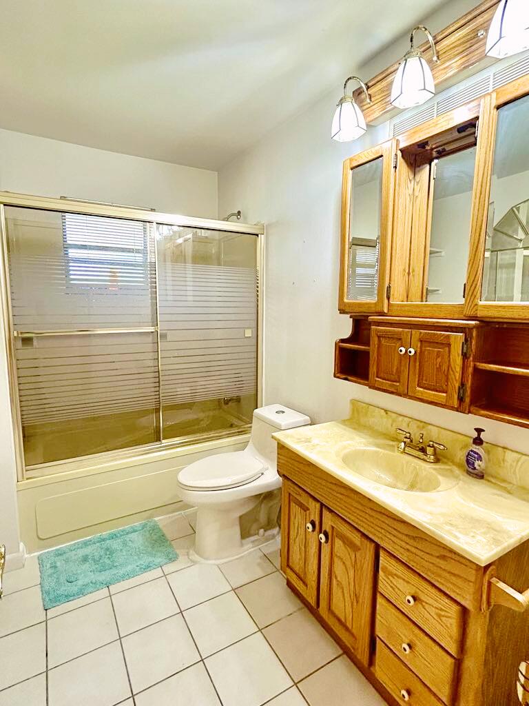 2657 River Road Moore Haven, FL 33471 - Photo 7 of 25 a bathroom with a granite countertop sink toilet mirror and bathtub