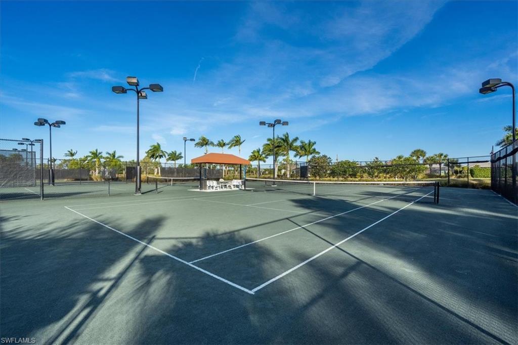 6509 Dominica Drive, Unit 101 Naples, FL 34113 - Photo 32 of 33 a view of an outdoor space and tennis court