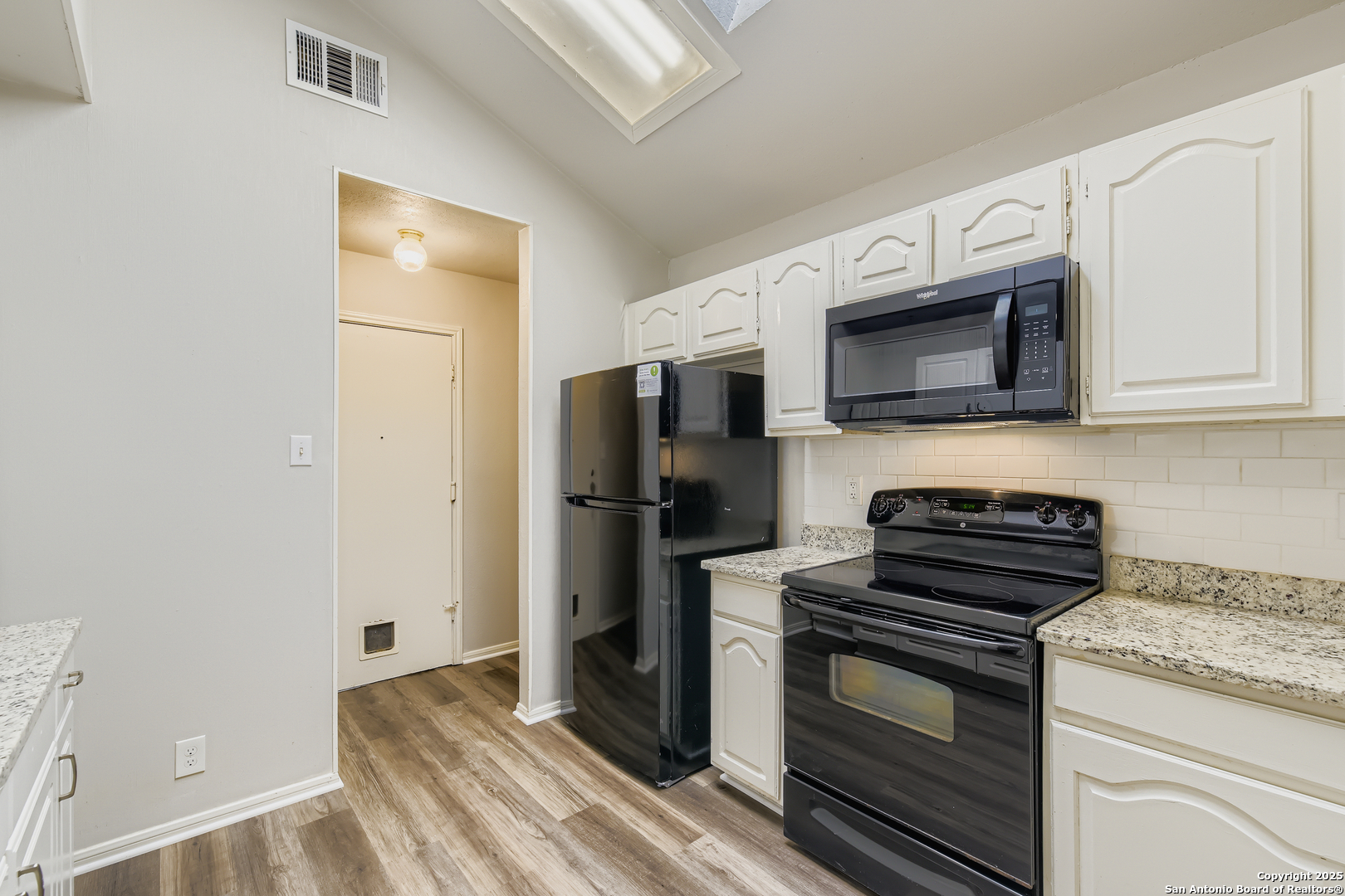 15018 Spring Shower San Antonio, TX 78247 - Photo 11 of 29 a kitchen with stainless steel appliances granite countertop a stove microwave and refrigerator