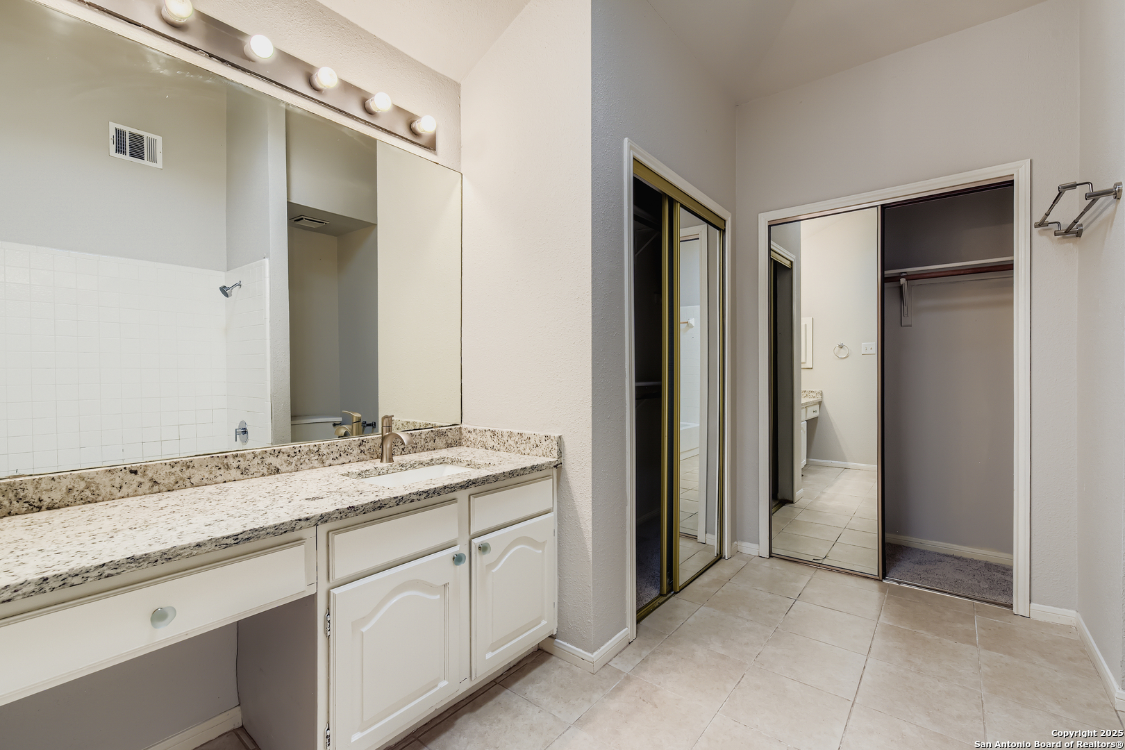 15018 Spring Shower San Antonio, TX 78247 - Photo 16 of 29 a spacious bathroom with a granite countertop sink and a mirror