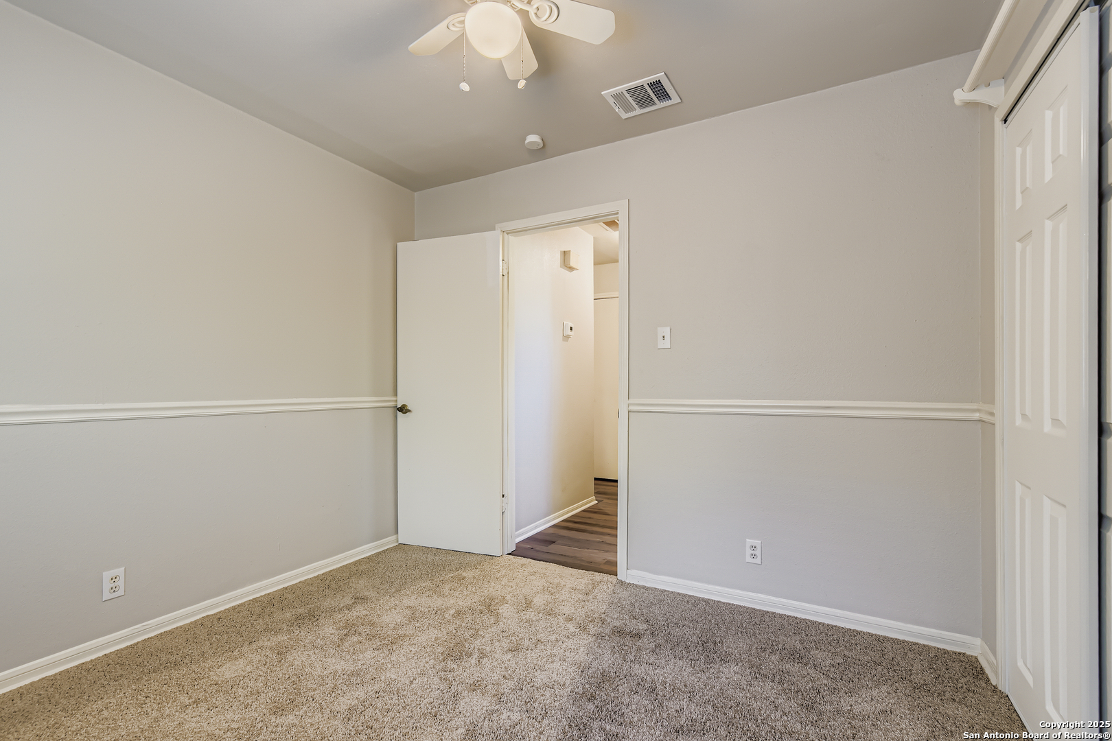 15018 Spring Shower San Antonio, TX 78247 - Photo 23 of 29 an empty room with closet and a chandelier fan