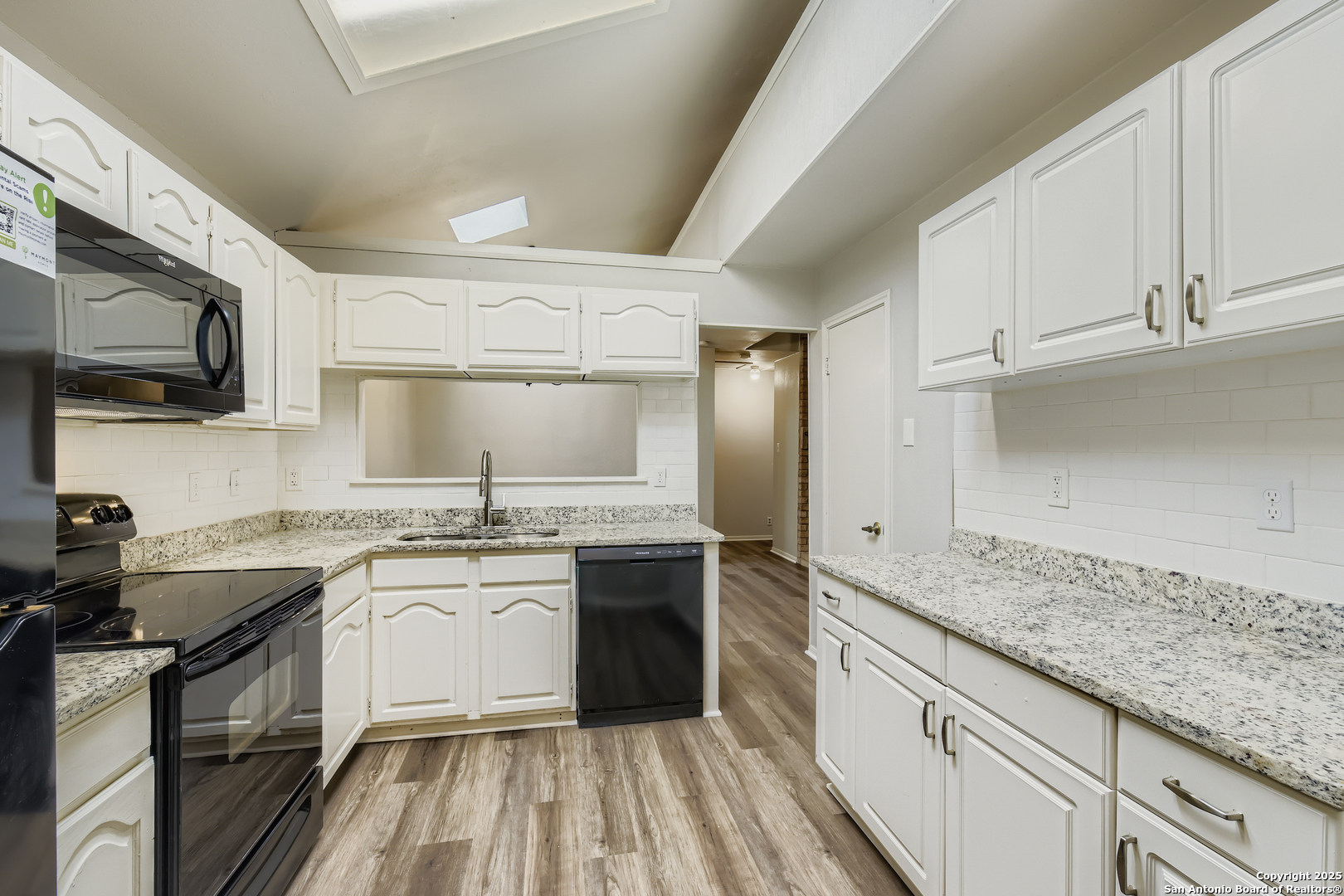 15018 Spring Shower San Antonio, TX 78247 - Photo 9 of 29 a kitchen with a sink stove top oven and cabinets