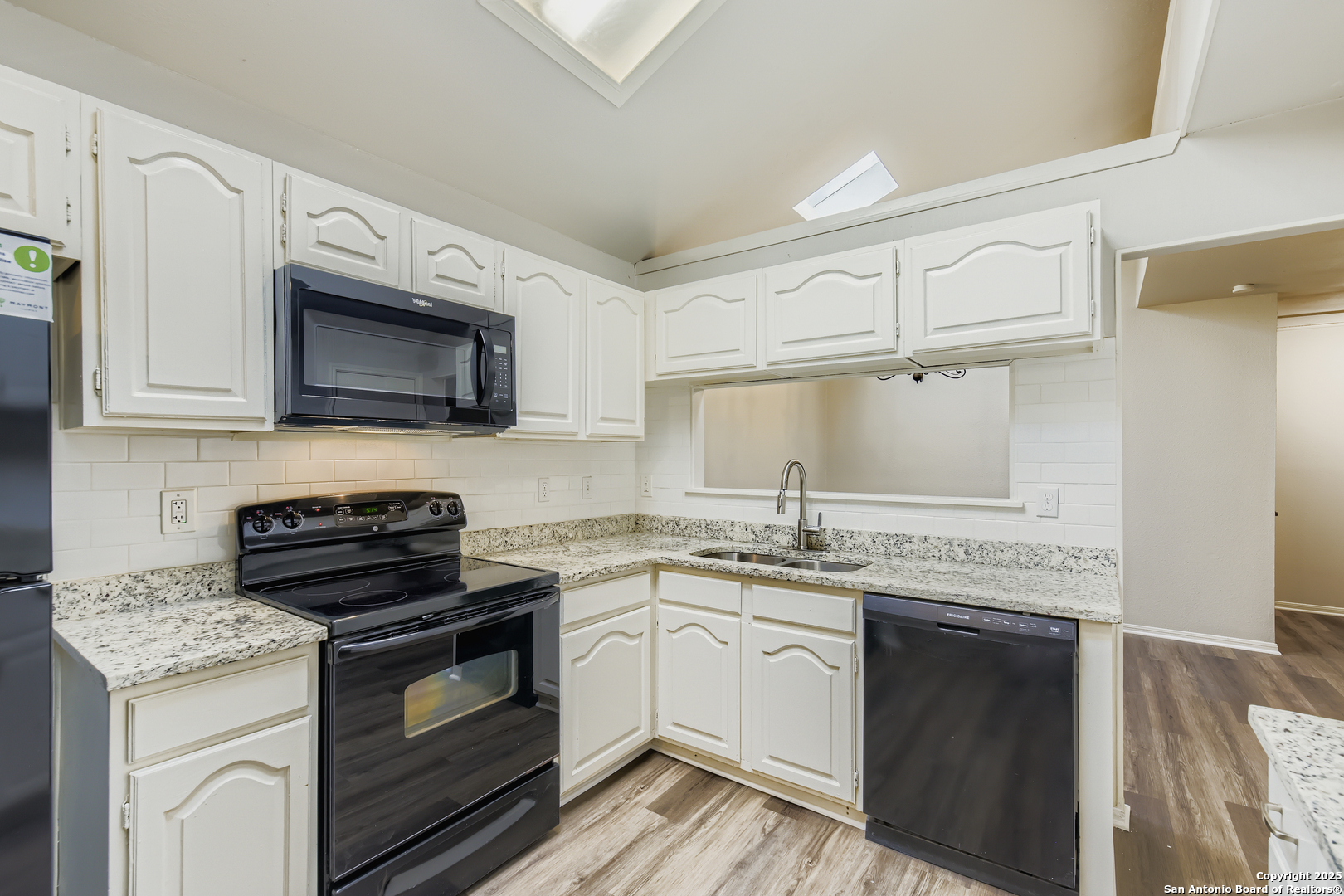 15018 Spring Shower San Antonio, TX 78247 - Photo 10 of 29 a kitchen with stainless steel appliances granite countertop a stove a sink and a microwave