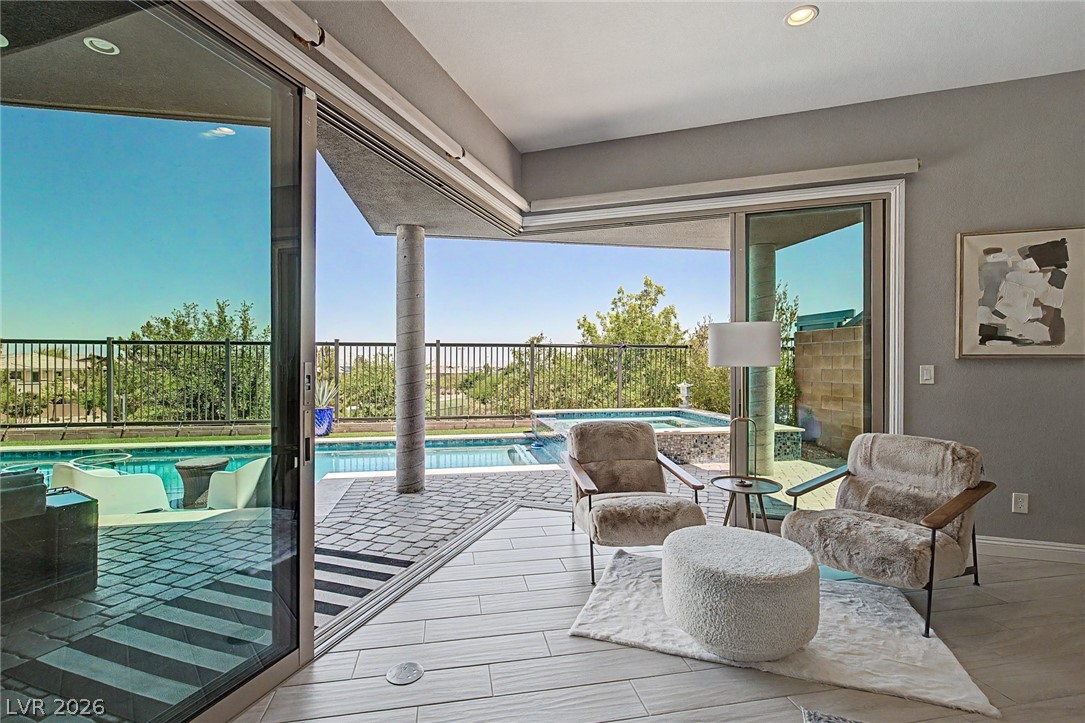 6014 Willow Ridge Court Las Vegas, NV 89135 - Photo 44 of 99 This inviting living area seamlessly transitions to a private outdoor oasis with a sparkling pool.