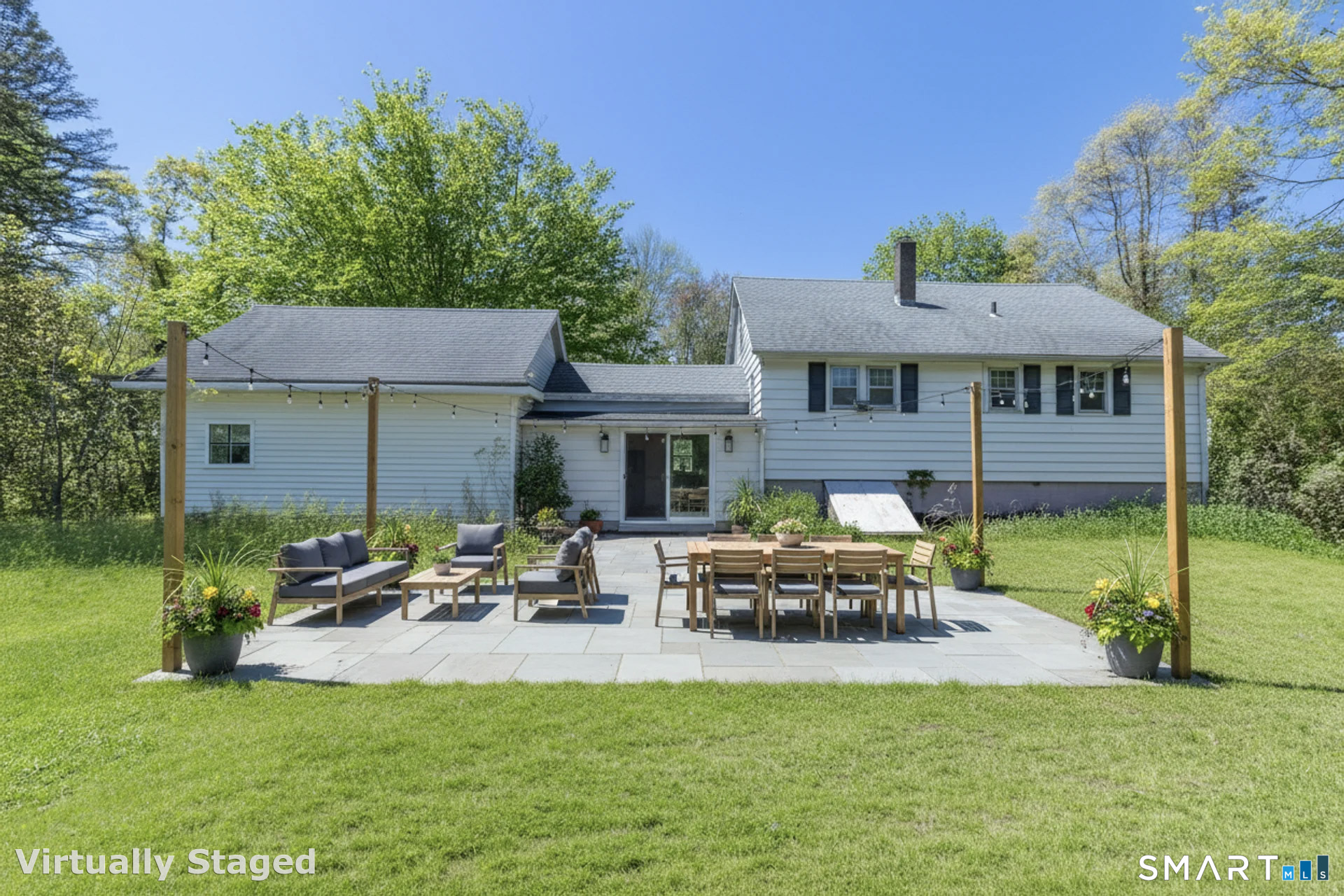 1973 Long Hill Road Guilford, CT 06437 - Photo 14 of 19 a view of a patio with table and chairs potted plants and a large tree