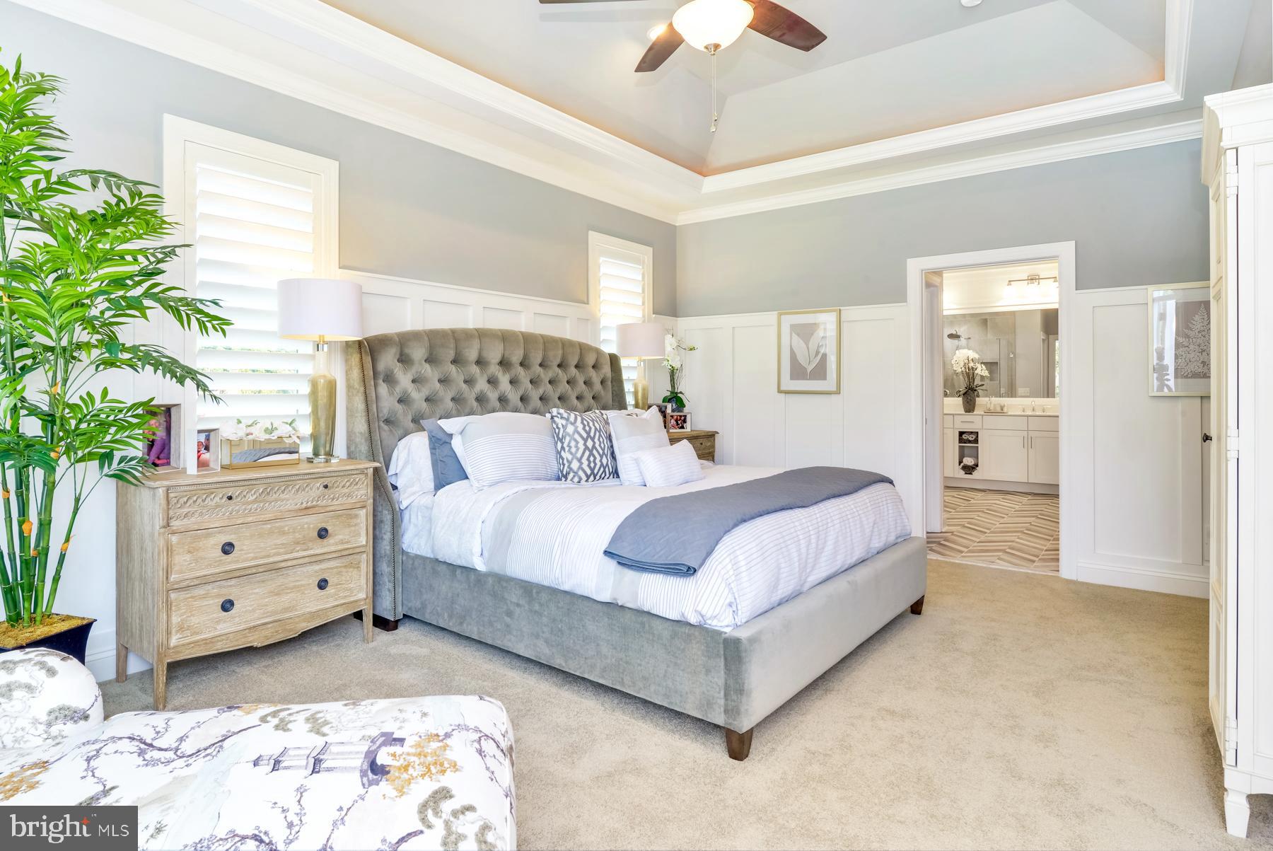 21804 Eastbridge Loop Lewes, DE 19958 - Photo 16 of 20 a bedroom with a bed and a potted plant
