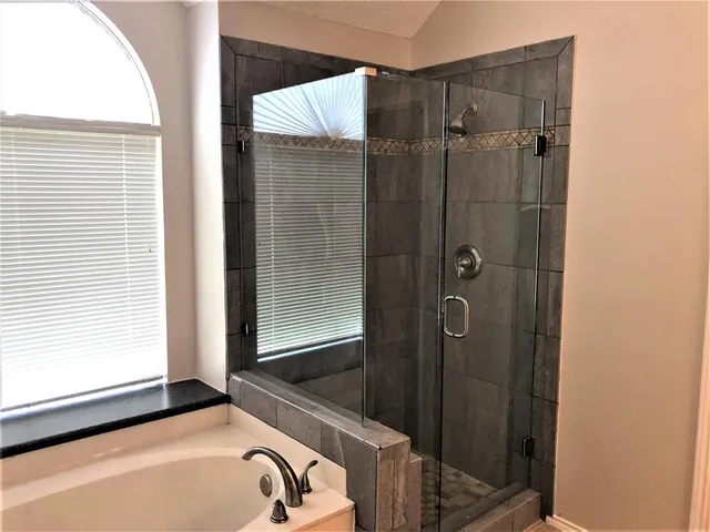 a bathroom with a shower and a tub