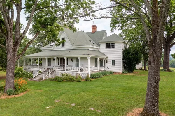 a front view of a house with a yard table and chairs