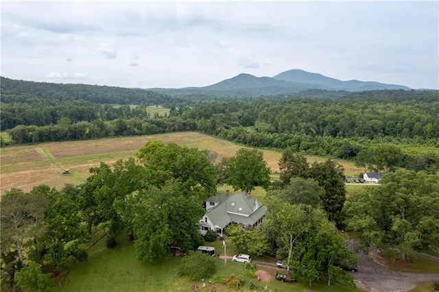 a view of a hallway with wooden floor and workspace