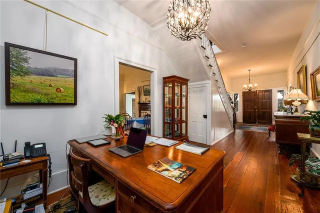 a living room with furniture a fireplace and wooden floor