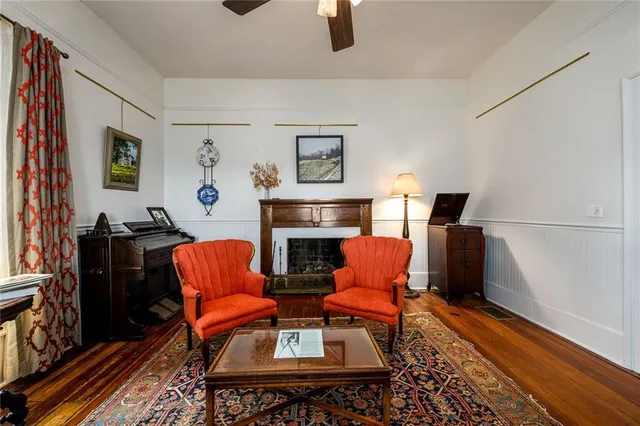 a dining room with furniture a chandelier and wooden floor