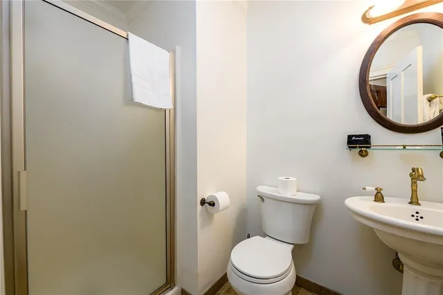 a view of a house with a big yard and large trees