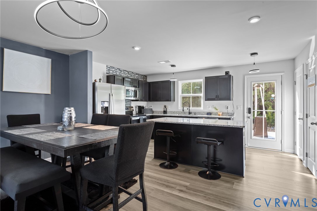 5466 Niles Road Richmond, VA 23234 - Photo 11 of 31 a kitchen with a table and chairs in it