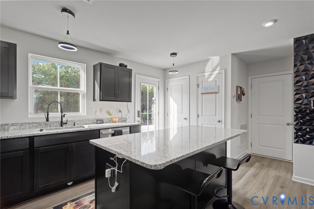 5466 Niles Road Richmond, VA 23234 - Photo 12 of 31 a kitchen with a sink stainless steel appliances and cabinets