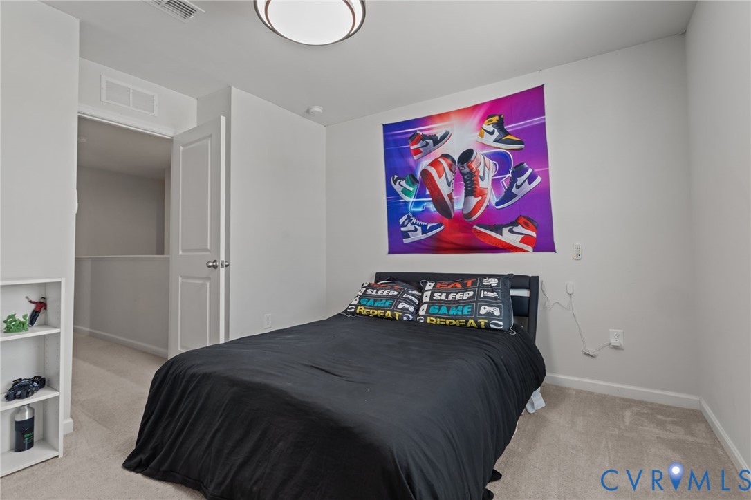 5466 Niles Road Richmond, VA 23234 - Photo 21 of 31 a bedroom with a bed and painting on the wall