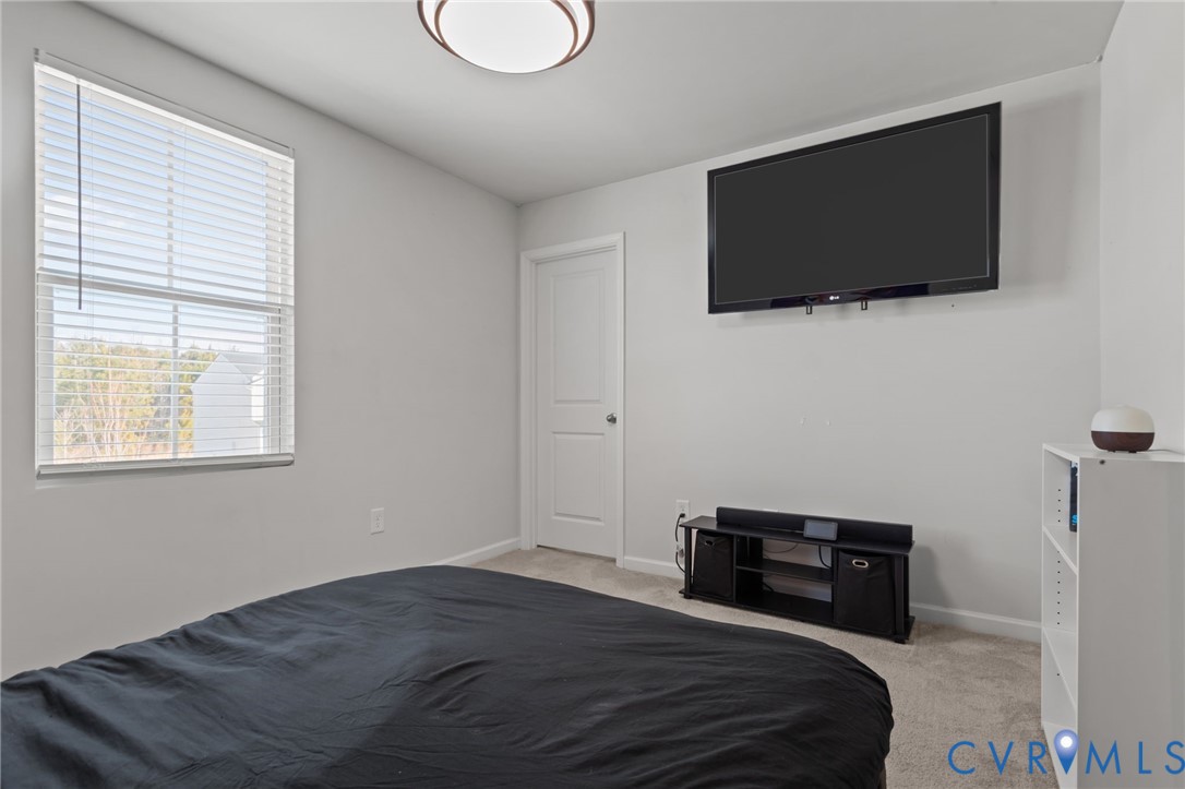 5466 Niles Road Richmond, VA 23234 - Photo 22 of 31 a bedroom with a bed and a flat screen tv