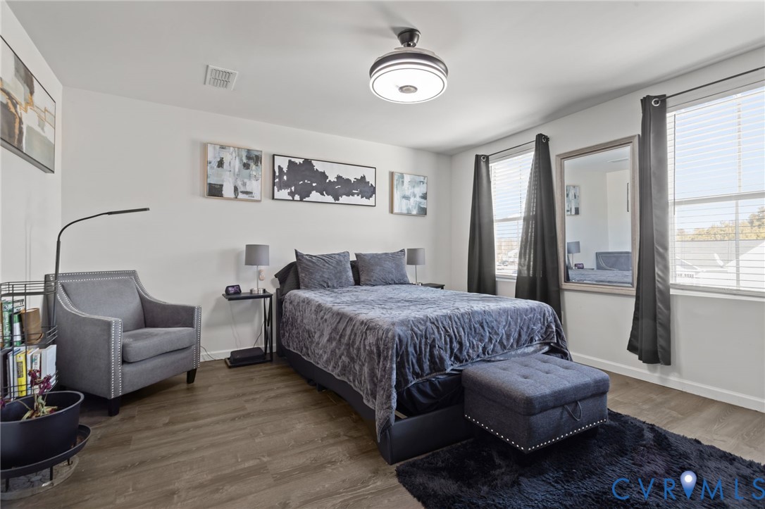 5466 Niles Road Richmond, VA 23234 - Photo 26 of 31 a spacious bedroom with a bed couch and a window