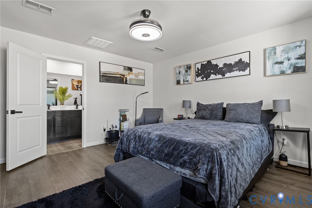 5466 Niles Road Richmond, VA 23234 - Photo 27 of 31 a spacious bedroom with a bed and wooden floor