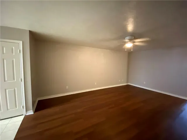 a view of wooden floor and windows in a room