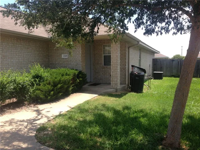 a backyard of a house with yard and outdoor seating