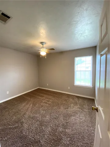 an empty room with a empty space and windows