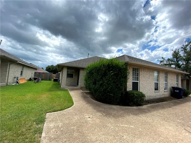 a front view of house with a garden