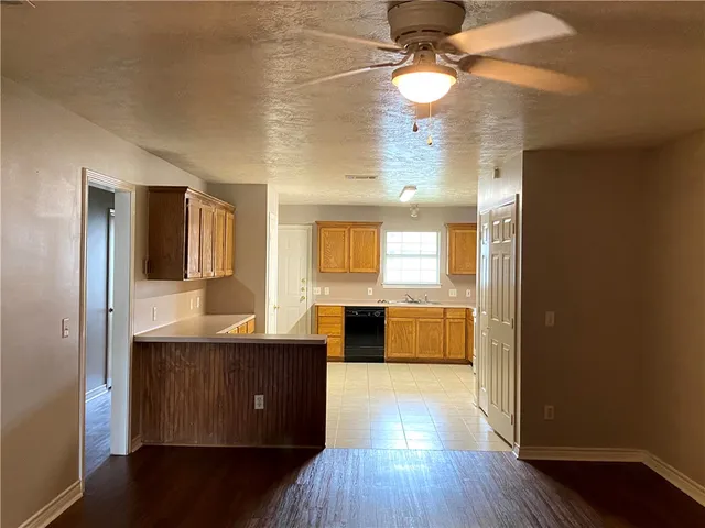 a view of a room with wooden floor and cabinet