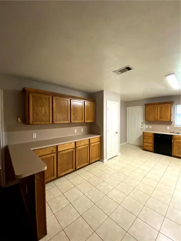 a kitchen with stainless steel appliances granite countertop a sink and cabinets