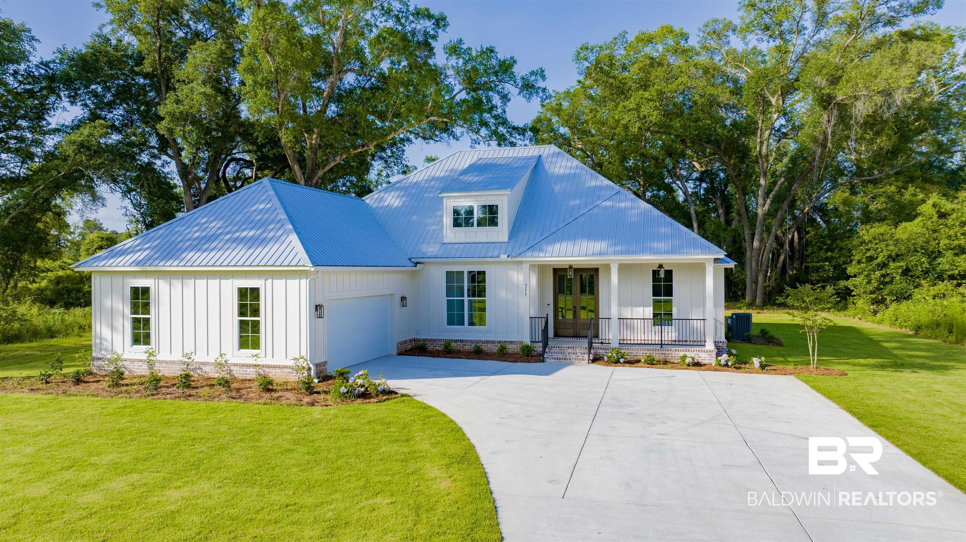 9275 Clarke Ridge Road Foley, AL 36535 - Photo 4 of 43 Modern inspired farmhouse featuring board and batten siding, covered porch, concrete driveway, a front yard, and an attached garage
