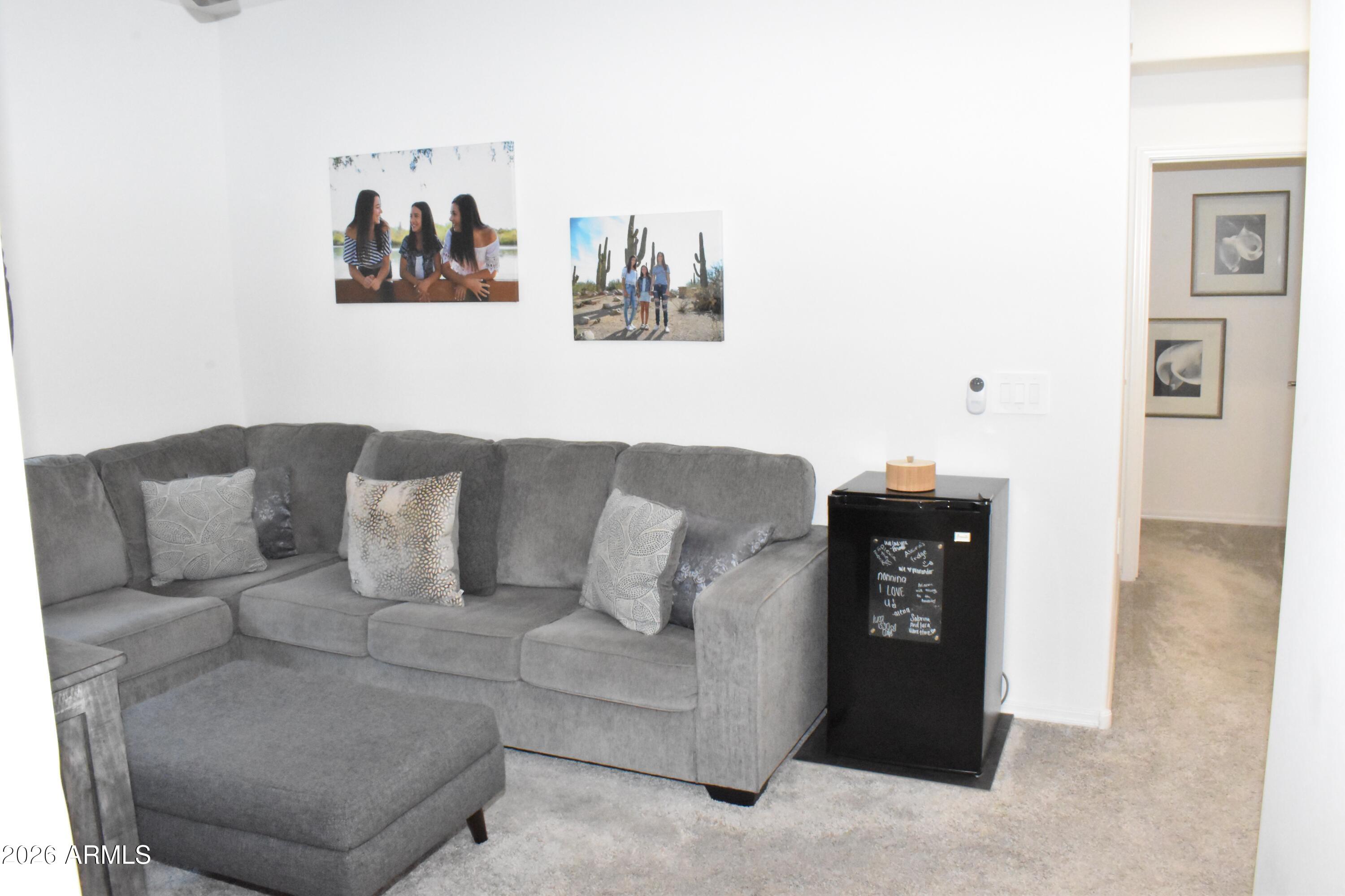 1821 East Bernie Lane, Unit 107 Gilbert, AZ 85295 - Photo 11 of 39 a living room with furniture and a wall painting