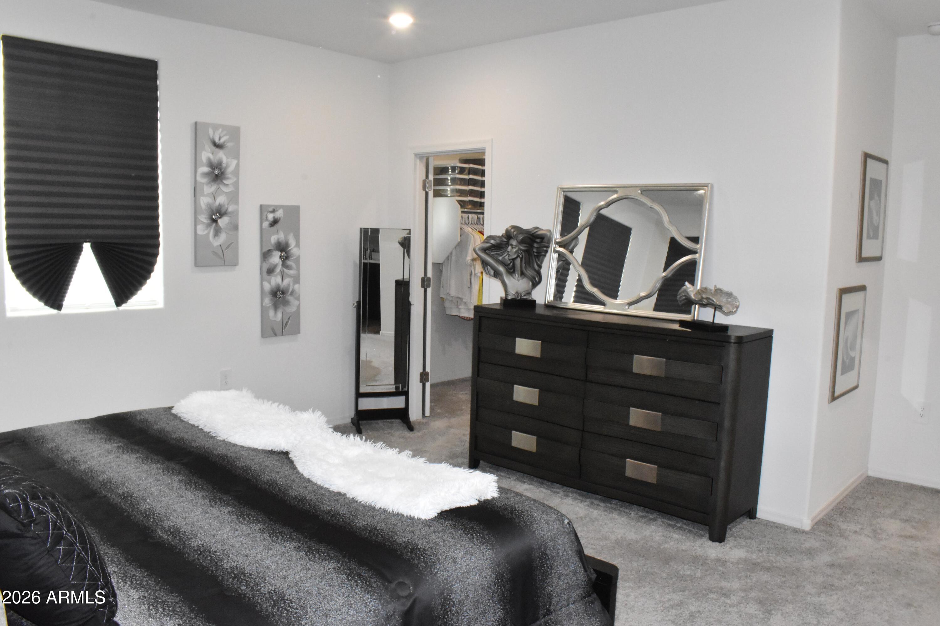 1821 East Bernie Lane, Unit 107 Gilbert, AZ 85295 - Photo 15 of 39 a bedroom with a bed and a dresser