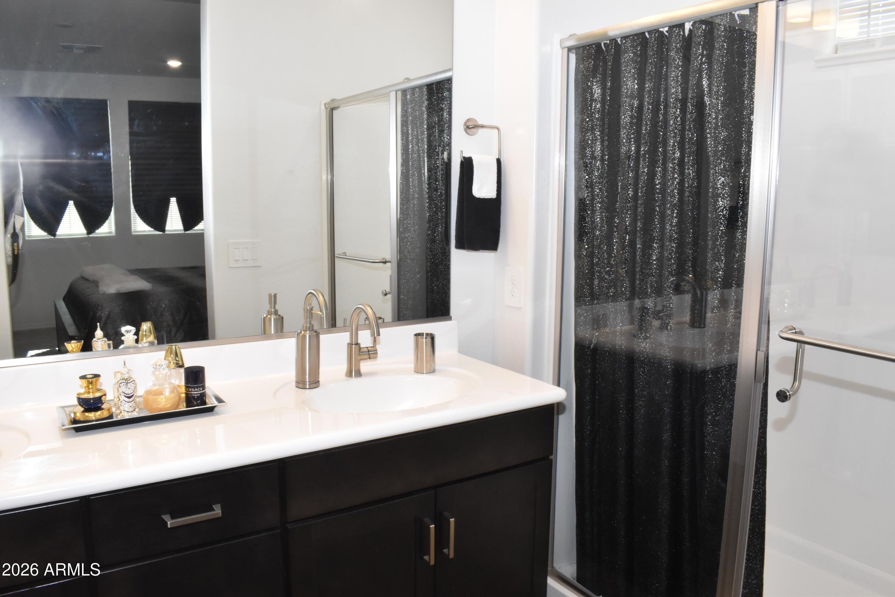 1821 East Bernie Lane, Unit 107 Gilbert, AZ 85295 - Photo 18 of 39 a bathroom with a sink double vanity and a mirror