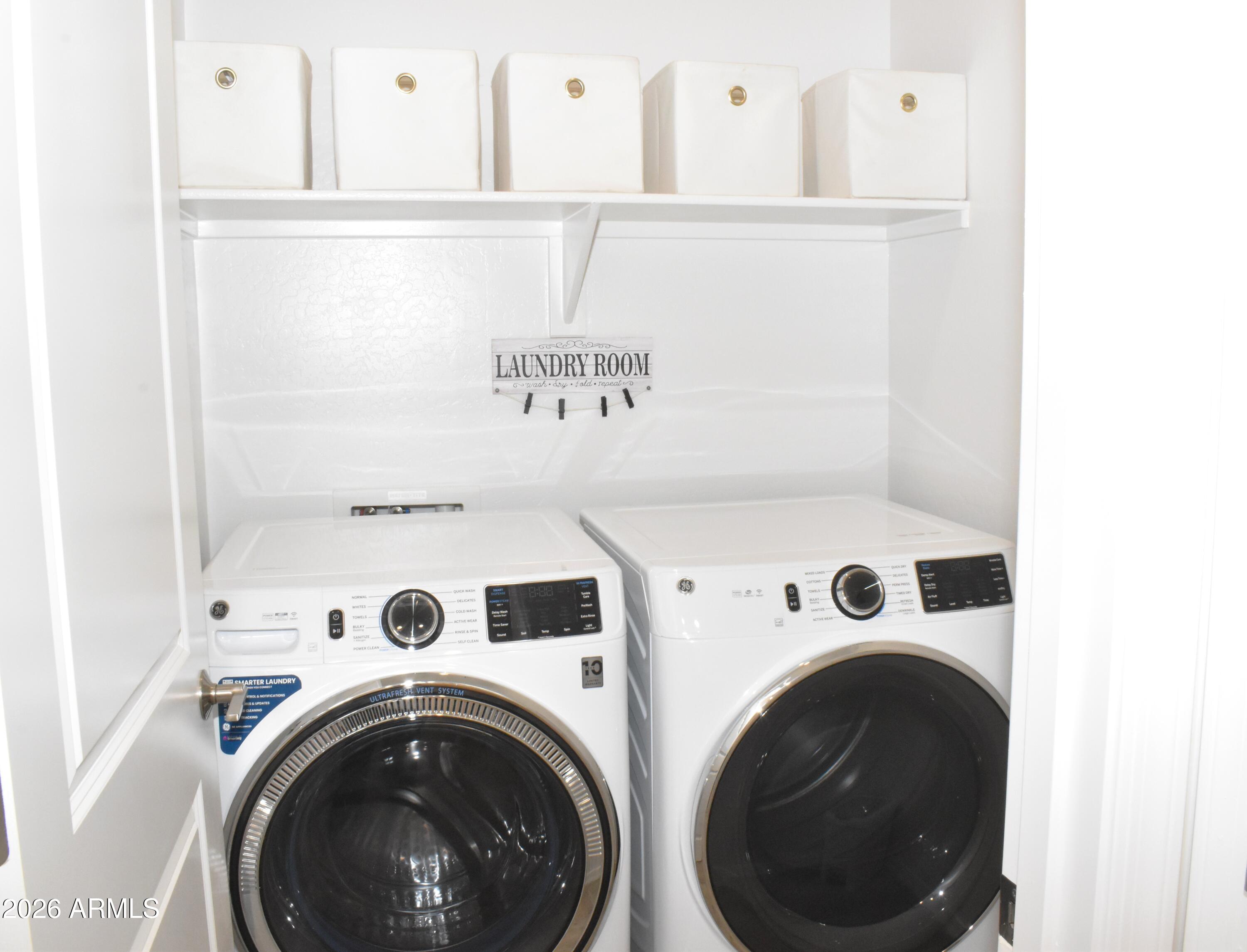 1821 East Bernie Lane, Unit 107 Gilbert, AZ 85295 - Photo 25 of 39 a view of washer and dryer with kitchen in the background