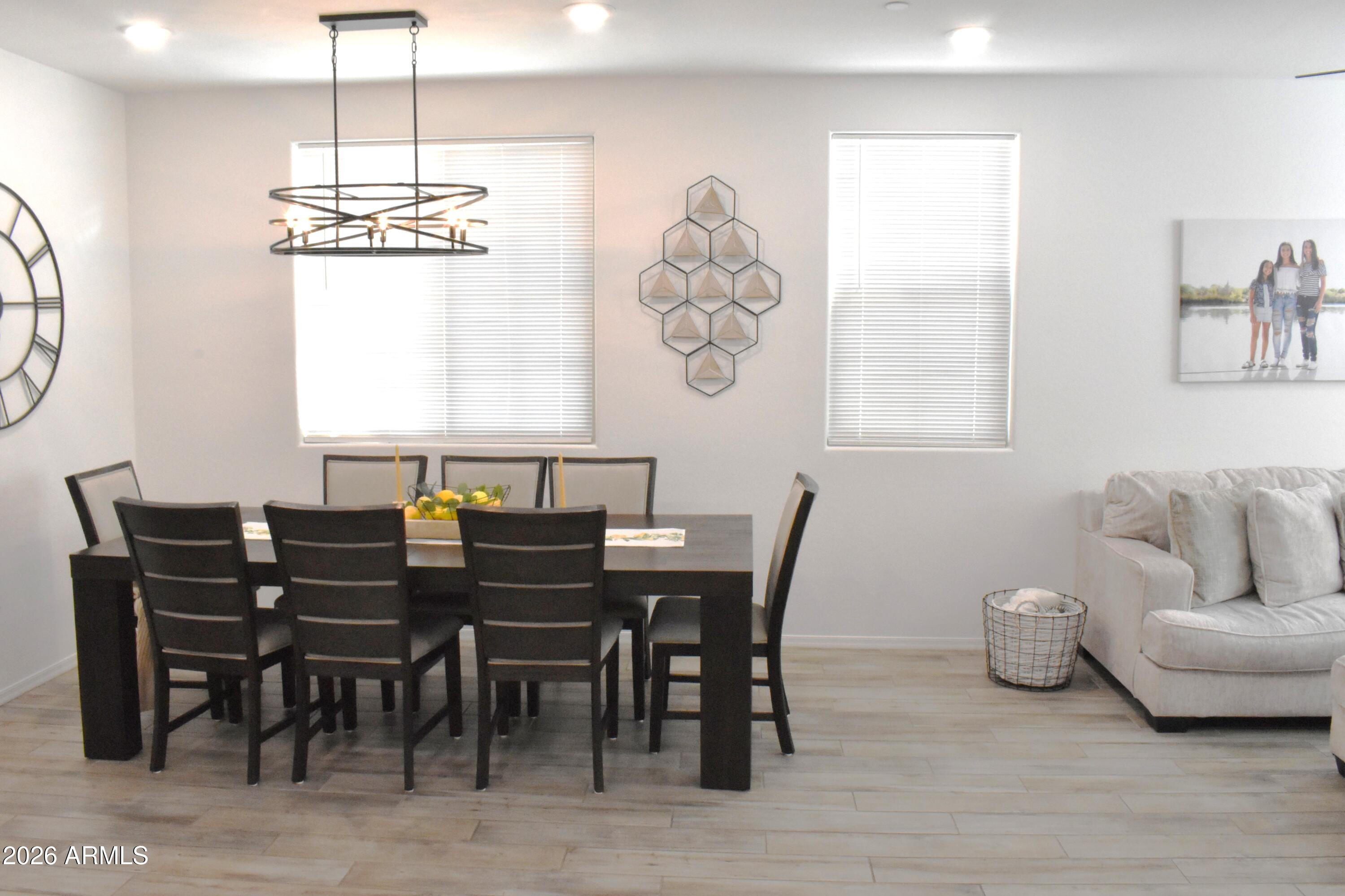 1821 East Bernie Lane, Unit 107 Gilbert, AZ 85295 - Photo 7 of 39 a view of a dining room with furniture window and wooden floor