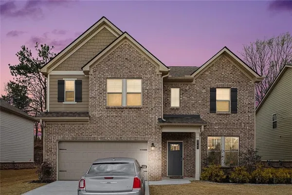 a front view of a house with a yard