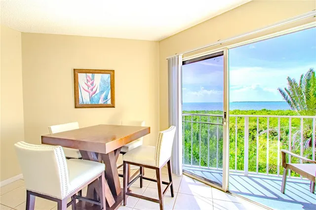a view of a dining room with furniture a chandelier and wooden floor